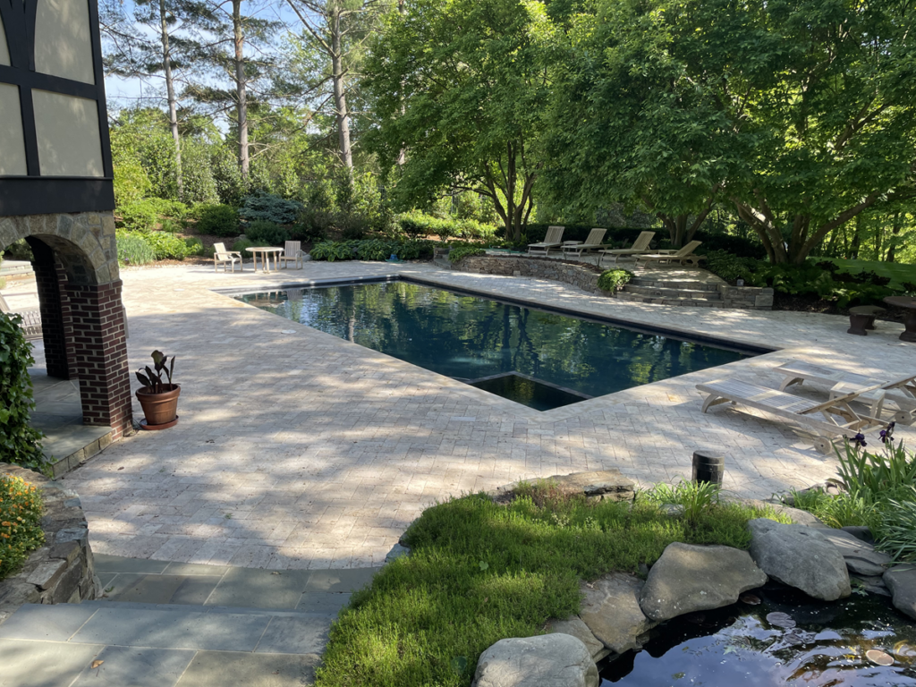 Oyster (beige-grayish) Travertine Pavers in herringbone pattern.