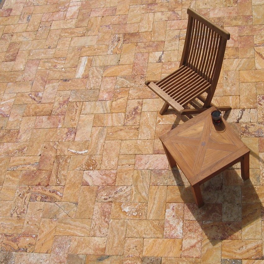 Peach yellow travertine pavers on patio with chair and table | natural stone products | Gothic Stone